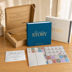 Everything in the box: the CheriBOO Baby Memory Book in Deep Sea Blue, its keepsake box, thank-you card and two sticker sheets
