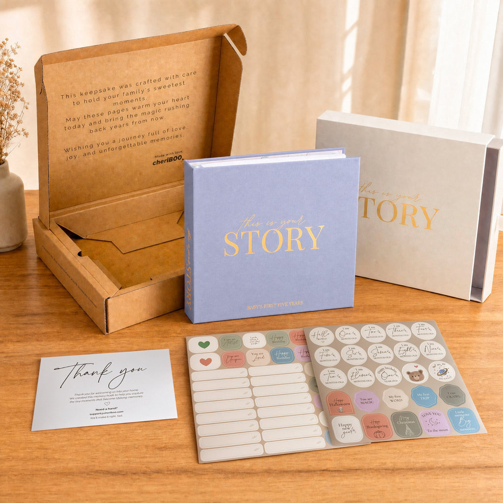 Everything in the box: the CheriBOO Baby Memory Book in Lavender, its keepsake box, thank-you card and two sticker sheets