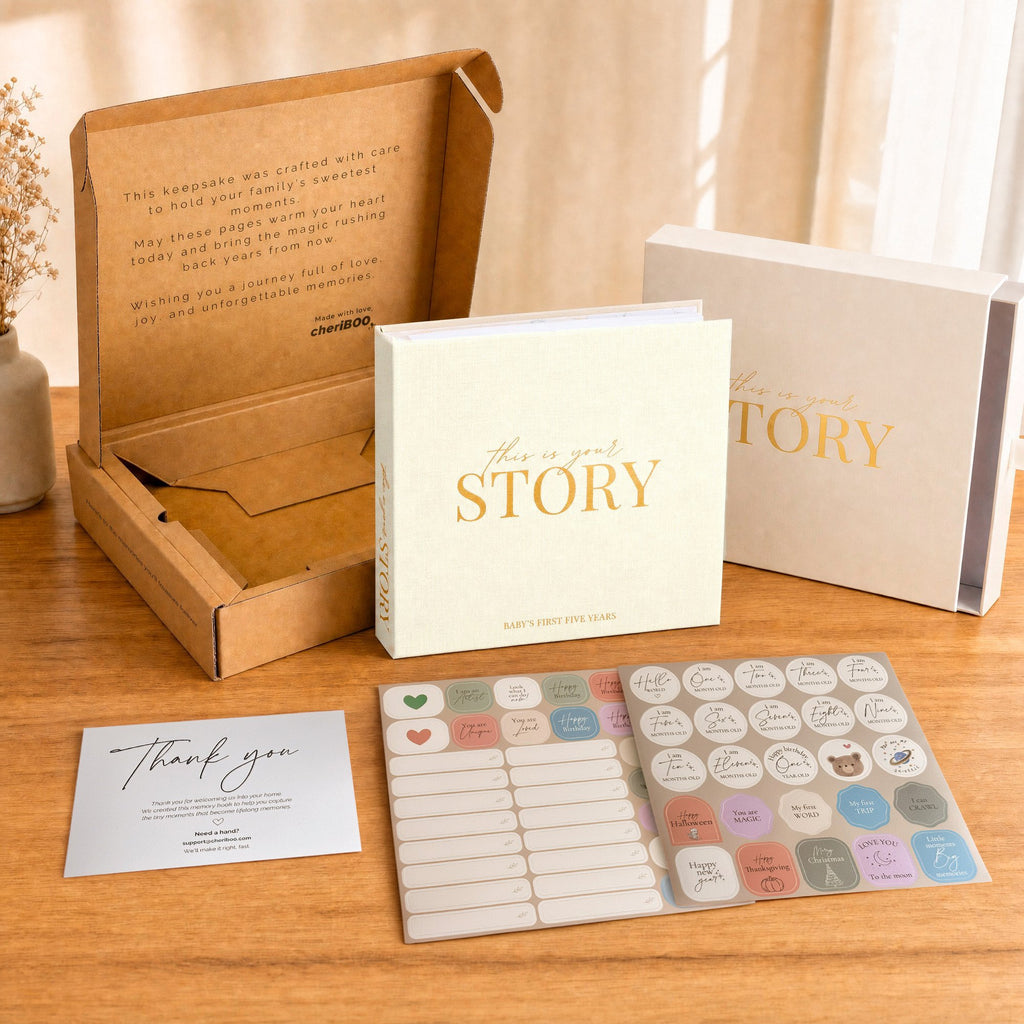 Everything in the box: the CheriBOO Baby Memory Book in Natural, its keepsake box, thank-you card and two sticker sheets