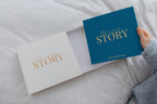 CheriBOO Baby Memory Book in Deep Sea Blue (deep petrol blue) sliding out of its keepsake box