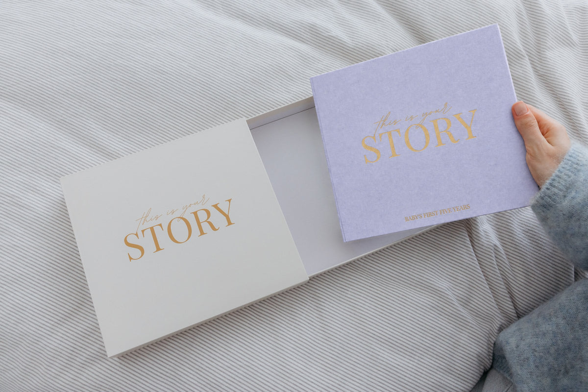 CheriBOO Baby Memory Book in Lavender (soft grayish lavender) sliding out of its keepsake box