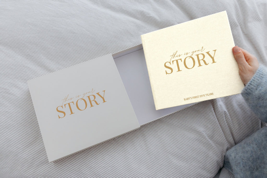 CheriBOO Baby Memory Book in Natural (warm cream) sliding out of its keepsake box