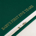 Close-up of the linen cover, the gold foil and the thick pages of the CheriBOO Baby Memory Book in Evergreen