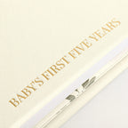 Close-up of the linen cover, the gold foil and the thick pages of the CheriBOO Baby Memory Book in Natural