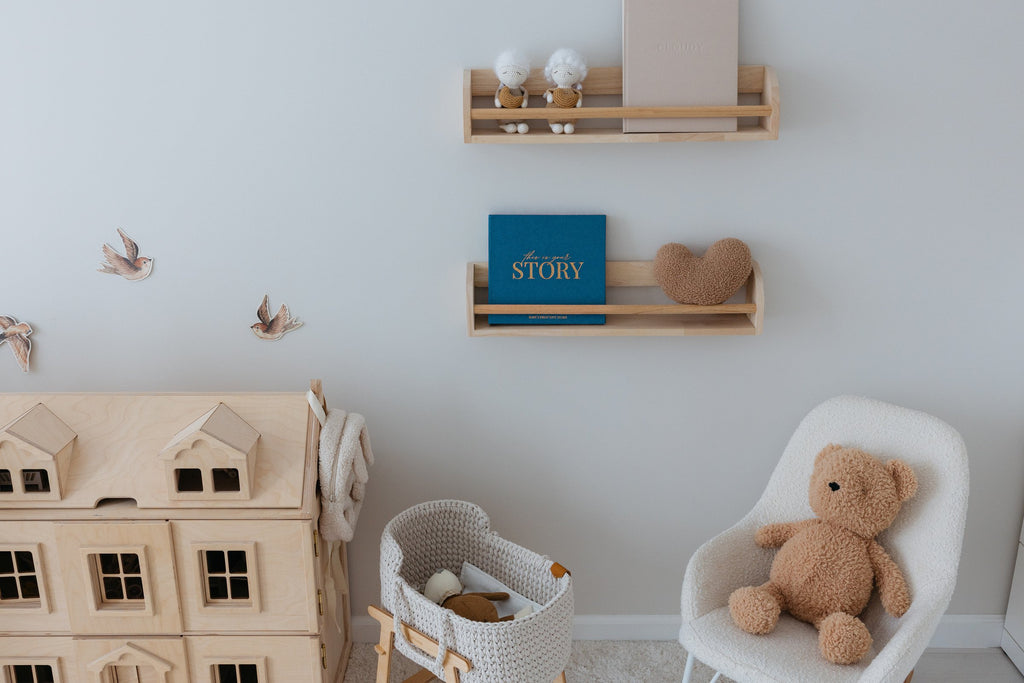 The CheriBOO Baby Memory Book in Deep Sea Blue on a nursery shelf