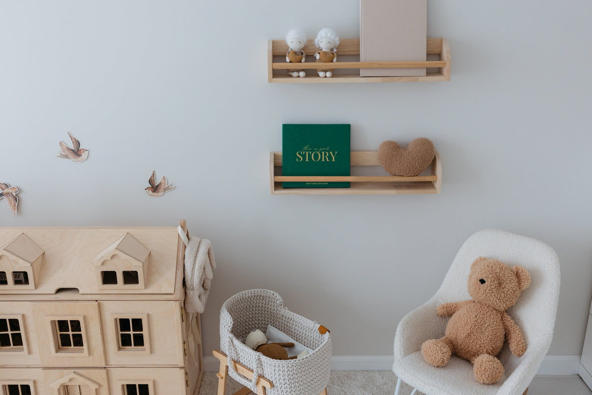 The CheriBOO Baby Memory Book in Evergreen on a nursery shelf