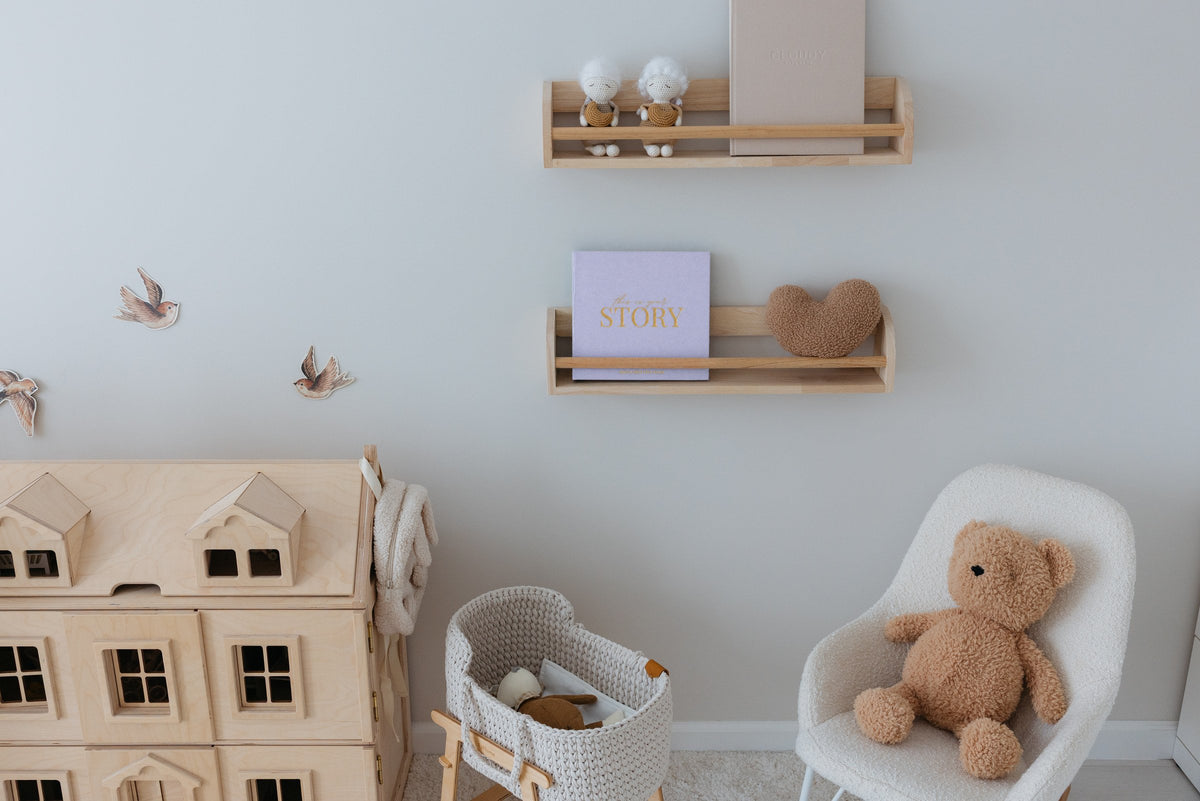 The CheriBOO Baby Memory Book in Lavender on a nursery shelf