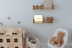 The CheriBOO Baby Memory Book in Natural on a nursery shelf