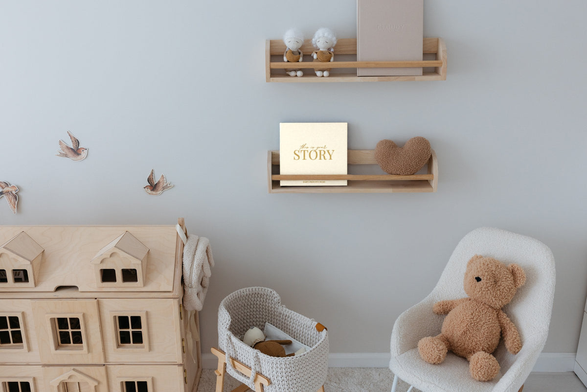 The CheriBOO Baby Memory Book in Natural on a nursery shelf