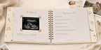 The CheriBOO Baby Memory Book in Natural open on the ultrasound page, with printed photos beside it